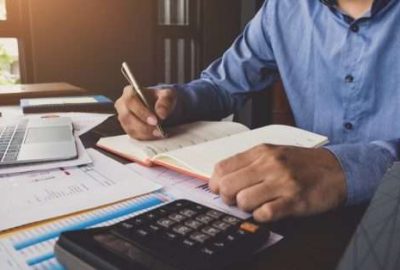 boise id cpa looks over numbers on ledgers for client