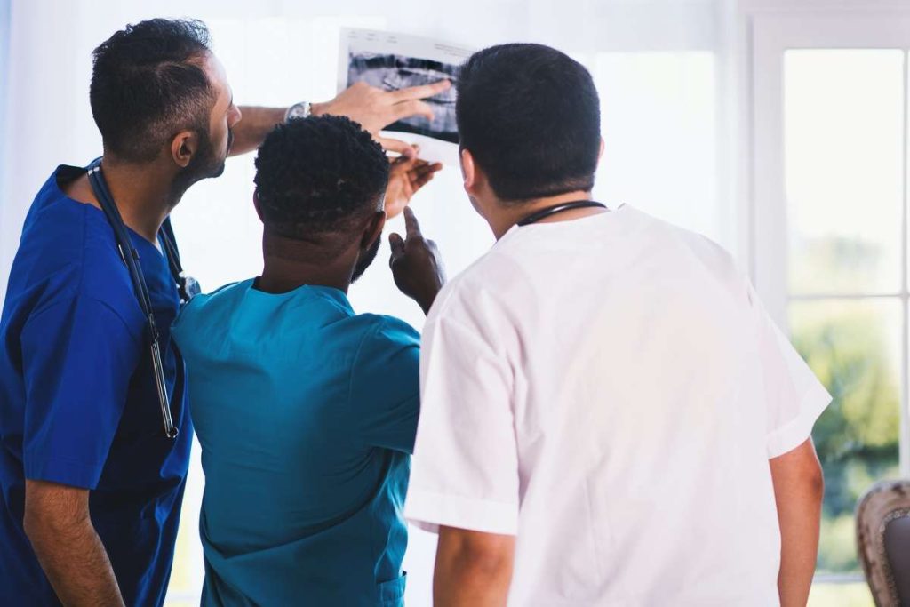 doctors gathered around an x ray