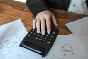 calculator and worksheets representing technology tools for small business