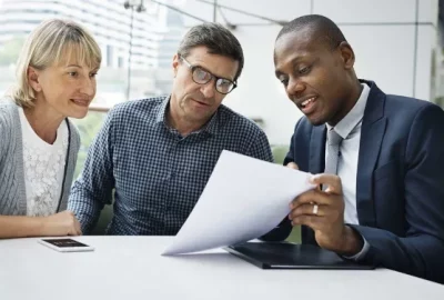 People sitting at table looking over papers